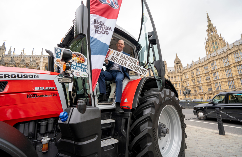 Kieran on red tractor at Parliament for Back British Farming Day