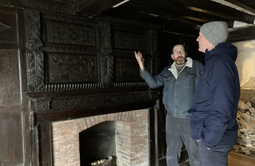 Inside the Mint House looking at fireplace are Kieran Mullan with Project Manager Joe Seaman