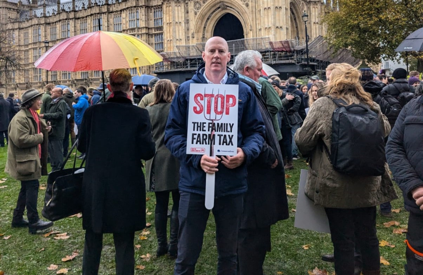 Kieran with placard outside Parliament