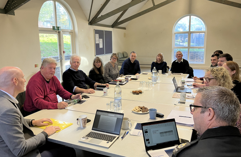 Kieran in meeting room in Robertsbridge with members of parish council, Sussex Police and National Highways