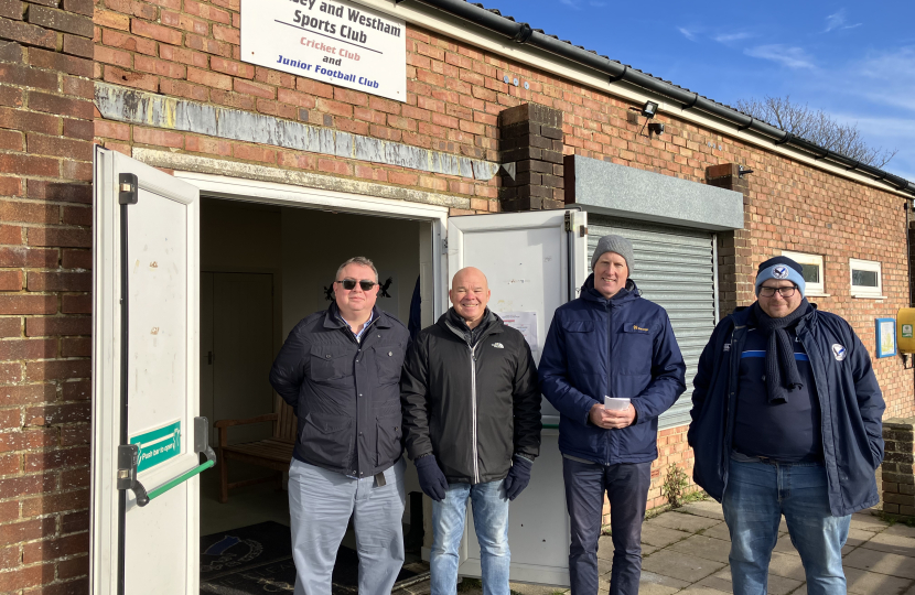 Kieran with Cllr Peter Lawton and club chairman standing outside sports pavilion 