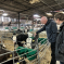 Kieran stroking calf on local diary farm stood next to farmer