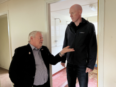 Kieran talking with Cllr Andrew Barton inside the sports pavilion