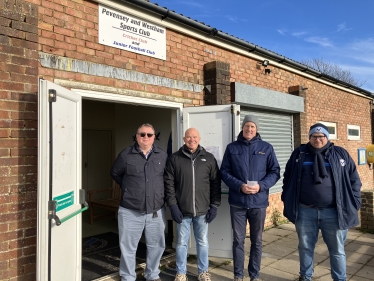 Kieran with Cllr Peter Lawton and club chairman standing outside sports pavilion 